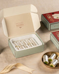 Dadu's Badam Pista Roll gift box open showing rolls with silver varq