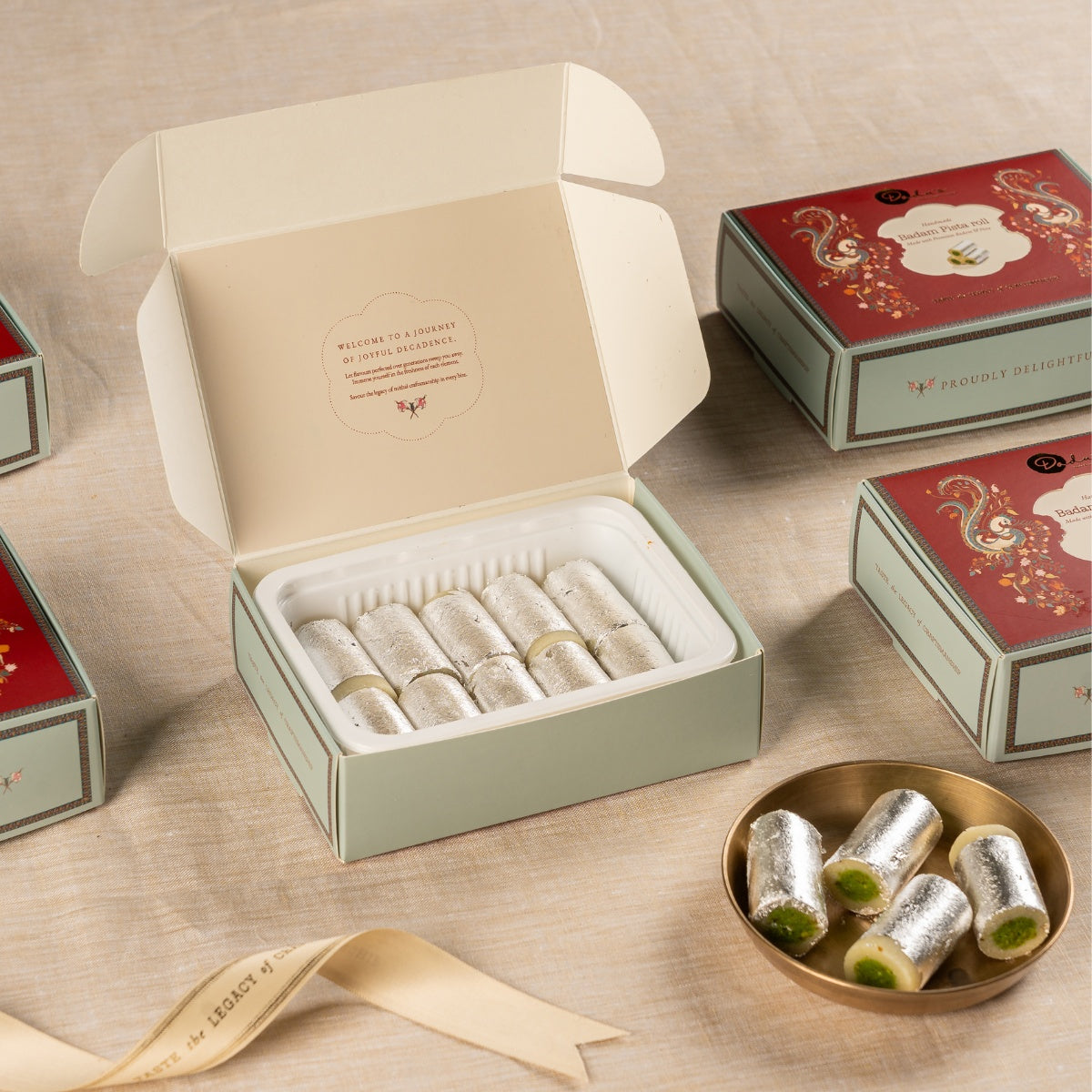 Dadu's Badam Pista Roll gift box open showing rolls with silver varq
