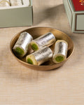 Dadu's Badam Pista Roll pieces with silver varq on serving plate