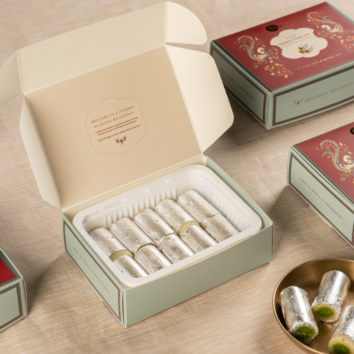 Sliced Badam Pista Roll showing green pista and almond layers, Dadu's Hyderabad